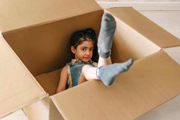Portrait of little girl inside a cardboard box model released Symbolfoto property released ERRF03670