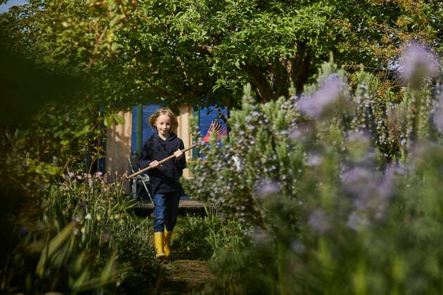 Girl in allotment garden holding a rake model released Symbolfoto property released MCF00815