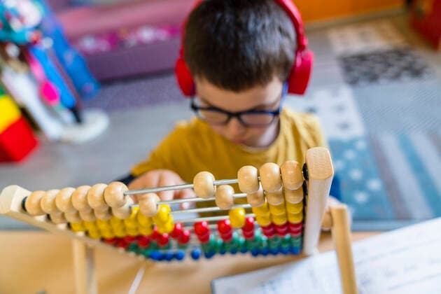 Boy calculating with abacus while sitting at home model released Symbolfoto property released MGIF00961