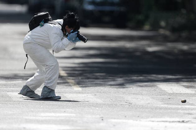 (200627) -- MEXICO CITY, June 27, 2020 (Xinhua) -- An investigator takes photos of an evidence at the scene where Mexico City Chief of Police Omar Garcia Harfuch was attacked by gunmen in Mexico City, Mexico, June 26, 2020. A group of gunmen opened fire on Mexico City Chief of Police Omar Garcia Harfuch and his bodyguards on Friday morning, injuring him and killing two officers and a civilian, according to local authorities. (Photo by Francisco Canedo Xinhua) MEXICO-MEXICO CITY-POLICE CHIEF-ATTACK 