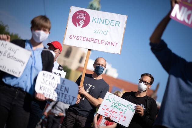 Right to education and care secure relieve parents Under the slogan right to education and care secure relieve parents protest parents with their children before the meeting of the Berlin Senate in front of the Red City Hall Parents demand a relief during the Corona crisis by a reopening of th