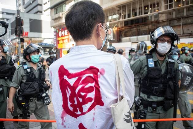 June 28, 2020, Hong Kong, China: A protester with a message painted on his shirt is blocked by a group of riot police during the demonstration..Pro-democracy protesters marched from Jordan to Mong Kok, in Hong Kong face strong police presence. The march was disrupted by riot police in few different sections. Demonstrators never finished the march. Hong Kong China - ZUMAs197 20200628_zaa_s197_181 Copyright: xIvanxAbreux