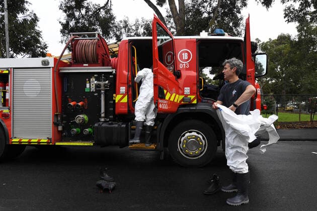 PUBLIC HOUSING COVID-19 CLUSTER MELBOURNE, Firefighters dress in personal protective equipment as they prepare to distribute food throughout a public housing tower in North Melbourne, Tuesday, July 7, 2020. Nine towers in Flemington and North Melbourne were locked down on Saturday in an effort to slow the spread of coronavirus, with 3000 residents unable to leave their apartments for any reason for at least five days. ( NO ARCHIVING, EDITORIAL USE ONLY, NO USE IN BOOKS WITHOUT CONSENT MELBOURNE VIC AUSTRALIA  Copyright: xJAMESxROSSx 20200707001478527116