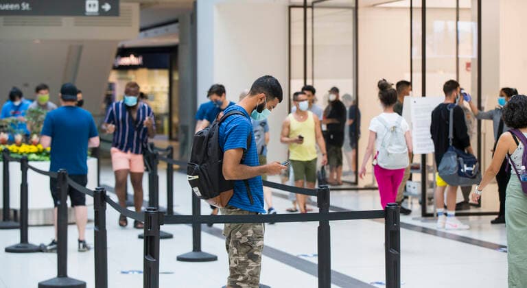(200707) -- TORONTO, July 7, 2020 -- Customers wearing face masks line up to enter an Apple store in Toronto, Canada, on July 7, 2020. The use of face coverings in indoor, publicly accessible settings became mandatory in the City of Toronto on Tuesday. (Photo by Xinhua) CANADA-TORONTO-COVID-19-FACE MASK REQUIREMENT ZouxZheng 