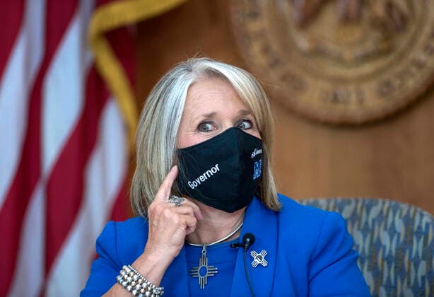 July 9, 2020, USA: Governor Michelle Lujan Grisham shows her face mask with Governor and St. Michael s High School emblem on it. This was before giving her weekly update on the COVID-19 outbreak in New Mexico and the state effort to control it. The news conference is being held at the Roundhouse in Santa Fe, Thursday July 9, 2020. USA - ZUMAab1_ 20200709_zaf_ab1_009 Copyright: xEddiexMoorex