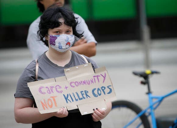 (200711) -- VANCOUVER, July 11, 2020 -- A protester participates in the anti police brutality rally in Vancouver, British Columbia, Canada, July 11, 2020. Thousands of people in several cities in British Columbia took part in the anti police brutality rally on Saturday. (Photo by Xinhua) CANADA-VANCOUVER-ANTI POLICE BRUTALITY-PROTEST LiangxSen 