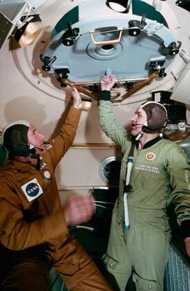 PICTURE SHOWS: (25 Feb. 1975) -- An interior view of the Soyuz orbital module mock-up in Building 35 during Apollo-Soyuz Test Project joint crew training at NASA s Johnson Space Center. The ASTP crewmen are astronaut Vance D. Brand (on left), command module pilot of the American ASTP prime crew; and cosmonaut Valeriy N. Kubasov, engineer on the Soviet ASTP first (prime) crew. The training session simulated activities on the second day in Earth orbit. ... STORY COPY: ANNIVERSARY (17 July 1975): Cold War Rivals Met in Space On July 17, 1975, something momentous happened: two Cold War-rivals met in space. When their respective spacecraft rendezvoused and docked, a new era of cooperative ventures in space began. For more than a decade, A Copyright: xx 40719941 EDITORIAL USE ONLY. NOT FOR USE BY NEWSPAPERS BASED IN THE UK.