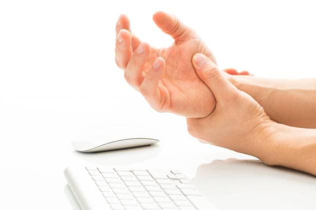 Working too much - suffering from a Carpal tunnel syndrome Working too much - suffering from a Carpal tunnel syndrome - young man holding his wrist in pain due to prolonged use of keyboard and mouse over white background (color toned image shallow DOF)  Copyright: xViktorxCapx 13535282