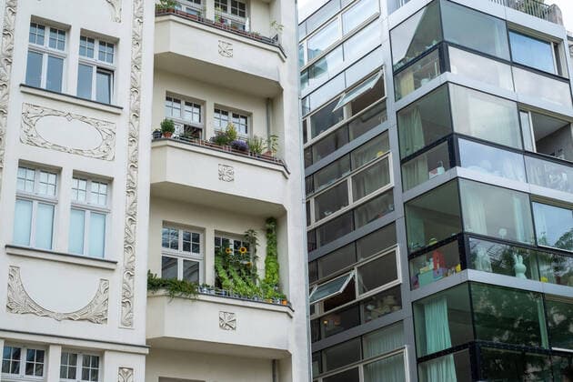 Renovated residential building from the Wilhelminian period next to a new building with glass facade in the Lychener Strasse in Berlin Prenzlauer Berg Alt and new building in Berlin
