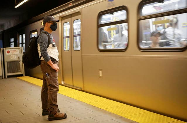 (200718) -- VANCOUVER, July 18, 2020 -- A passenger wearing a face mask waits to ride a SkyTrain in Vancouver, British Columbia, Canada, on July 18, 2020. As new COVID-19 cases in British Columbia continued to tick upwards, health officials urged those who can to wear a mask on transit and in other confined spaces, such as grocery stores. (Photo by Xinhua) CANADA-VANCOUVER-COVID-19-FACE MASKS LiangxSen 