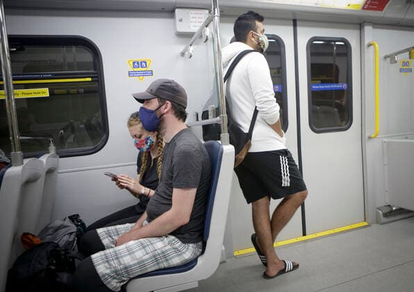 (200718) -- VANCOUVER, July 18, 2020 -- Passengers wearing face masks ride a SkyTrain in Vancouver, British Columbia, Canada, on July 18, 2020. As new COVID-19 cases in British Columbia continued to tick upwards, health officials urged those who can to wear a mask on transit and in other confined spaces, such as grocery stores. (Photo by Xinhua) CANADA-VANCOUVER-COVID-19-FACE MASKS LiangxSen 