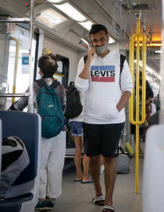(200718) -- VANCOUVER, July 18, 2020 -- A passenger wearing a face mask rides a SkyTrain in Vancouver, British Columbia, Canada, on July 18, 2020. As new COVID-19 cases in British Columbia continued to tick upwards, health officials urged those who can to wear a mask on transit and in other confined spaces, such as grocery stores. (Photo by Xinhua) CANADA-VANCOUVER-COVID-19-FACE MASKS LiangxSen 