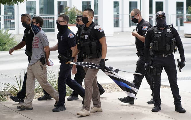 July 19, 2020, Albuquerque, NEW MEXICO, USA: 071920 ..A man is arrested by APD officers after showing up armed with a handgun at a rally at Civic Plaza in support of Black Lives Matter .Photographed on Sunday July 19, 2020.Adolphe Pierre-LouisJournal. Albuquerque USA - ZUMAab1_ 20200719_zaf_ab1_012 Copyright: xAlbuquerquexJournalx