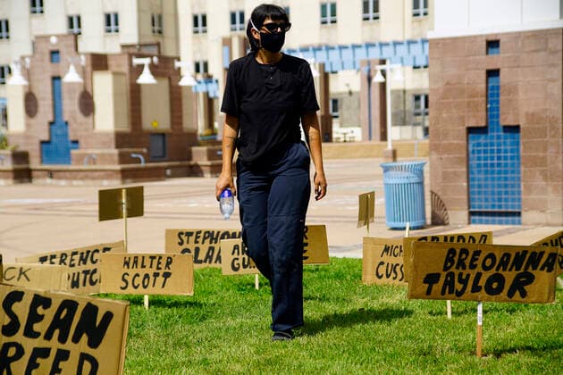 July 19, 2020, Albuquerque, NEW MEXICO, USA: 071920 ..Hailey walks past signs with names of victims of Police brutality during a rally at Civic Plaza in support of Black Lives Matter .Photographed on Sunday July 19, 2020.Adolphe Pierre-LouisJournal. Albuquerque USA - ZUMAab1_ 20200719_zaf_ab1_010 Copyright: xAlbuquerquexJournalx