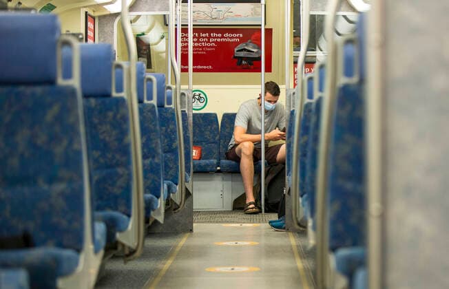 (200721) -- TORONTO, July 21, 2020 -- A passenger wearing a face mask rides a Go train in Toronto, Canada, on July 21, 2020. Starting Tuesday, Go Transit customers are required to wear masks or face coverings. (Photo by Xinhua) CANADA-TORONTO-COVID-19-MEASURES-GO TRANSIT ZouxZheng 