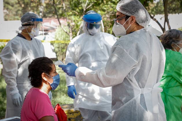 (200723) -- MEXICO CITY, July 23, 2020 (Xinhua) -- A medical worker checks body temperature of a woman in Mexico City, Mexico, July 22, 2020. Mexico s Health Ministry on Wednesday reported 6,019 new confirmed COVID-19 cases, bringing the total in the country to 362,274 cases. (Xinhua) MEXICO-MEXICO CITY-COVID-19 