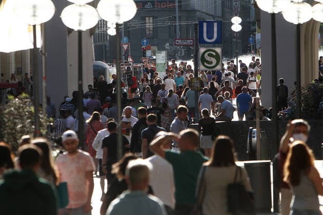After the relaxation of protective measures, the shopping street and pedestrian zone Neuhauser Straße with a view of Karlstor and Karlsplatz Stachus in the city centre of Munich looks again as it did before the corona crisis with a large crowd of people who largely do not keep the required minimum distance from each other, Bavaria, Germany