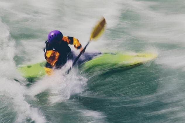Whitewater kayaker paddles and surds large river rapids on a fast flowing river Kayaking,United States,Whitewater kayaker paddles and surds large river rapids on a fast flowing river  Whitewater kayaker paddles and surds large river rapids on a fast flowing river