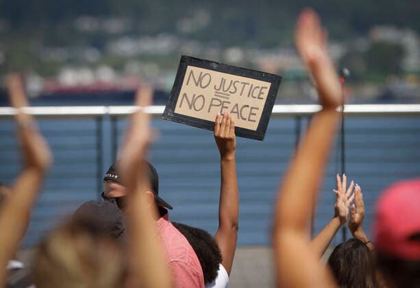 (200801) -- VANCOUVER, Aug. 1, 2020 -- A protestor holds up a sign while participating in the Emancipation Day march in Vancouver, British Columbia, Canada, August 1, 2020. In conjunction with the Black Lives Matter protest, thousands of people took part in a march to commemorate the Emancipation Day in Canada, which is marked on August 1. (Photo by Xinhua) CANADA-VANCOUVER-EMANCIPATION DAY MARCH LiangxSen 