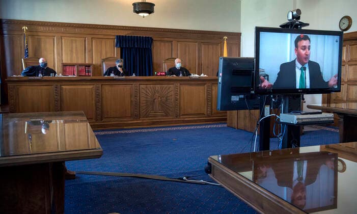 August 4, 2020, USA: Attorney Carter Harrison, right, representing a group that feels the Governor has exceeded her authority in closing businesses across the state due the COVID-19 health emergency, presents his case to the New Mexico Supreme Court. He and others appeared by video link during the healing in Santa Fe Tuesday August 4, 2020. USA - ZUMAab1_ 20200804_zaf_ab1_009 Copyright: xEddiexMoorex