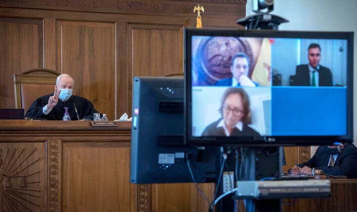 August 4, 2020, USA: Chief Justice of the New Mexico Supreme Court Michael Vigil delivers the justices decision to agree with the Governor who was challenged by a group that feels the Governor has exceeded her authority in closing businesses across the state due the COVID-19 health emergency. The attorneys Matt Garcia, representing the Governor, top left on the screen, Carter Harrison, representing the group opposing the Governor, top rigth, and Justice Barbara Vigil appeared by video link during the healing in Santa Fe Tuesday August 4, 2020. USA - ZUMAab1_ 20200804_zaf_ab1_011 Copyright: xEddiexMoorex