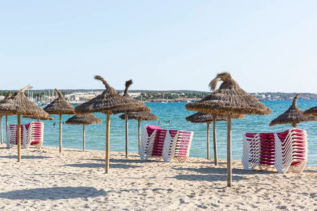 SPAIN, MALLORCA, PALMA DE MALLORCA, 07 08 2020 Stacked sun loungers and parasols on an empty beach section of Playa de Palma in the evening sun in the early evening Compared to previous years there are fewer tourists on site Reason is the current Corona Pandemic