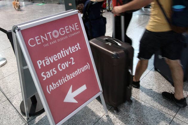 Large crowd of people returning and entering the country at a Centogene Covid 19 test centre at Frankfurt Airport, who are tested on Corona after the end of their journey, Hesse, Germany