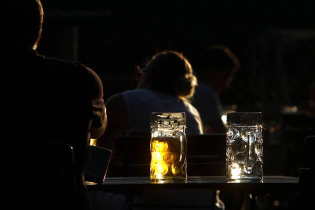 Maß Bier shines in the low n evening sun in the beer garden Königlicher Hirschgarten in Munich, Bavaria, Germany