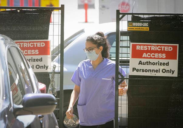 (200814) -- VANCOUVER, Aug. 14, 2020 -- A healthcare worker is seen at a COVID-19 testing facility in Vancouver, British Columbia, Canada, on Aug. 14, 2020. British Columbia s COVID-19 curve is now climbing at a higher rate than the initial outbreak in March, and new provincial modelling shows B.C. could see a second wave bigger than the first by September. (Photo by Xinhua) CANADA-VANCOUVER-COVID-19-TEST LiangxSen 