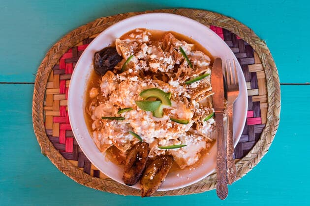 Chilaquiles with frijoles and fried plantains for breakfast in Ocosingo, Chiapas, Mexico. Chilaquiles are crispy fried tortilla chips, cooked in salsa and then sprinkled with cheese. Fried eggs are frequently added on top for breakfast. Ocosingo Chiapas Mexico Copyright: xJonxG.xFuller,xJr.x JGF-culture-food-MX-9236