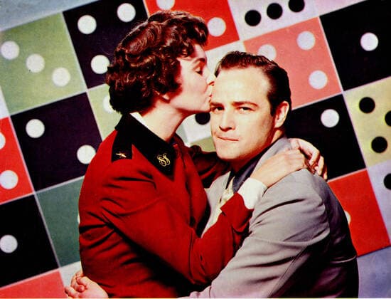 GUYS AND DOLLS JEAN SIMMONS, MARLON BRANDO Date: 1955. Strictly editorial use only in conjunction with the promotion of the film. Credit line mandatory. This image is copyright of the film company and is supplied under the terms of issue as film still. No commercial or book cover use permitted without prior consent from the film company.  Mandatory credit line: Image courtesy SAM GOLDWYTN COMPANY Ronald Grant Archive Mary Evans