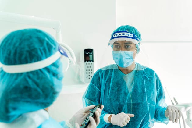 Female doctor talking to nurse in dentist s clinic model released Symbolfoto property released DLTSF00951
