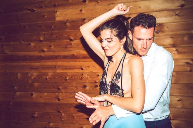 Young couple dancing against wooden wall in party model released Symbolfoto property released EHF00681