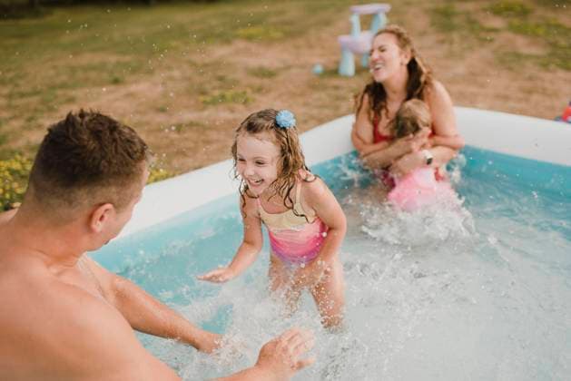 Happy family in an inflatable swimming pool in garden model released Symbolfoto property released SMSF00124