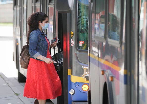 (200824) -- VANCOUVER, Aug. 24, 2020 -- A woman wearing a face mask gets on a bus in Vancouver, British Columbia, Canada, on Aug. 24, 2020. Anyone on board a TransLink or British Columbia (BC) Transit bus, boat or train and passengers on board BC Ferries vessels are required to wear a face mask beginning Monday to help stop the spread of COVID-19. (Photo by Xinhua) CANADA-BRITISH COLUMBIA-VANCOUVER-PUBLIC TRANSIT-FACE MASK-MANDATORY LiangxSen 