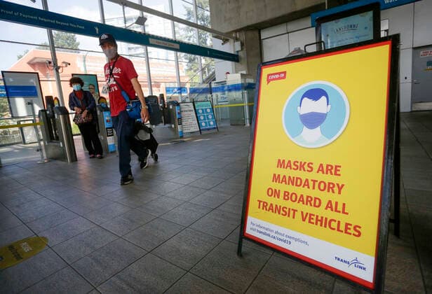 (200824) -- VANCOUVER, Aug. 24, 2020 -- A sign is seen at the entrance of a SkyTrain station to remind people of the new face mask policy in Vancouver, British Columbia, Canada, on Aug. 24, 2020. Anyone on board a TransLink or British Columbia (BC) Transit bus, boat or train and passengers on board BC Ferries vessels are required to wear a face mask beginning Monday to help stop the spread of COVID-19. (Photo by Xinhua) CANADA-BRITISH COLUMBIA-VANCOUVER-PUBLIC TRANSIT-FACE MASK-MANDATORY LiangxSen 