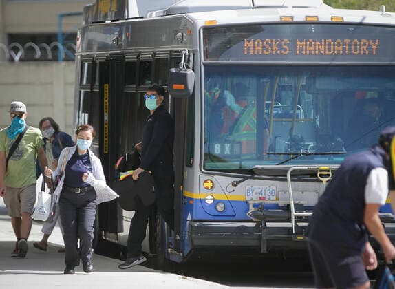 (200824) -- VANCOUVER, Aug. 24, 2020 -- People wearing face masks get off a bus in Vancouver, British Columbia, Canada, on Aug. 24, 2020. Anyone on board a TransLink or British Columbia (BC) Transit bus, boat or train and passengers on board BC Ferries vessels are required to wear a face mask beginning Monday to help stop the spread of COVID-19. (Photo by Xinhua) CANADA-BRITISH COLUMBIA-VANCOUVER-PUBLIC TRANSIT-FACE MASK-MANDATORY LiangxSen 