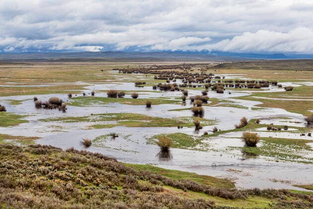 river meanders in a mountain valley Illinois River meanders through Arapaho National Wildlife Refuge, North Park near Walden, Colorado, spring scenery with flooded meadows  Copyright: xPixelsAwayx 13666494