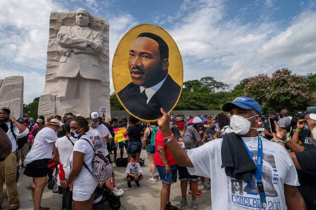 A man poses in front of the Martin Luther King Memorial following a Commitment Rally: Get Your Knee Off Our Necks at the Lincoln Memorial in Washington, DC on Friday, August 28, 2020. The 2020 March on Washington comes on the 57th anniversary of Dr. Martin Luther King s historic march, when he delivered his I Have a Dream speech.  WAP20200828261 KENxCEDENO