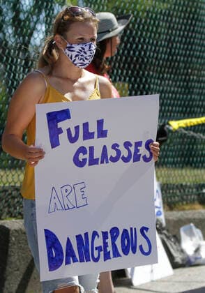(200829) -- VANCOUVER, Aug. 29, 2020 -- A woman attends the Safe September rally in Vancouver, British Columbia, Canada, on Aug. 29, 2020. A group of teachers and parents rallied Saturday demanding the province of British Columbia rethink its back-to-school plans. (Photo by Xinhua) CANADA-VANCOUVER-COVID-19- SAFE SEPTEMBER RALLY LiangxSen 