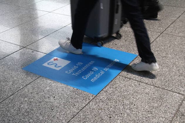 Signposts with directional arrows pointing to the Covid 19 test centers with Centogene smear center at Frankfurt Airport, Hesse, Germany