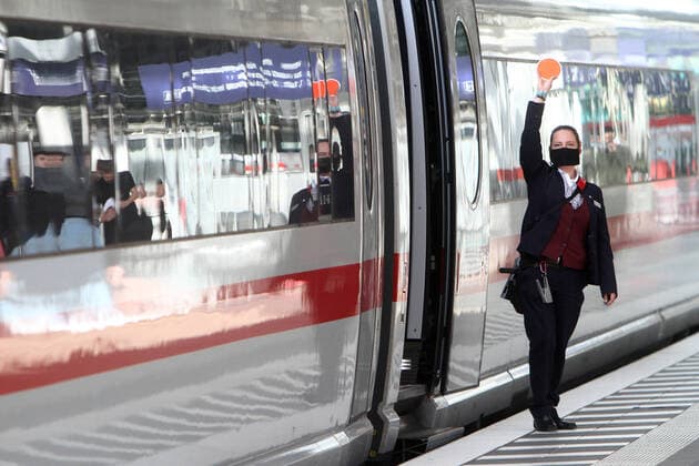 Train attendant of DB Deutsche n Bahn AG wears a mouth nose cover during the train clearance of an ICE at Frankfurt Central Station, Hesse, Germany