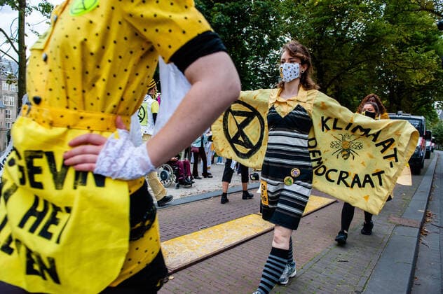 September 1, 2020, The Hague, South Holland, Netherlands: A model showing her dress with a climate message during the fashion show..An XR fashion show was carried out in front of the House of Representatives in The Hague. Models wore yellow, black, and white colourful second-hand outfits to symbolise the collectivity of bees, to show that thinking and working together can help us out of this crisis. The Hague Netherlands - ZUMAs197 20200901_zaa_s197_028 Copyright: xAnaxFernandezx