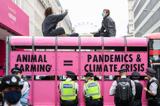 Bilder des Jahres 2020, News 09 September News Themen der Woche KW36 Mounting police personnel wearing face masks stand by Animal Rebellion activists, who glued themselves inside a pink Truck and parked it in Victoria Street outside the department for social care on Thursday, Sept 3, 2020. Environmental non-violent activists group Extinction Rebellion enters its 3rd day of continuous ten days to disrupt political institutions throughout peaceful actions swarming central London into a standoff, demanding that central government obeys and delivers Climate Emergency bill., Animal Rebellion Blocked Victoria Street London Victoria Street England United Kingdom  , Copyright: xVudixXhymshitix