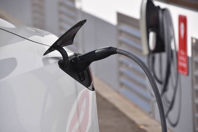 A Tasla Model 3 is charged at the charging station for TESLA electric vehicles, manufacturer of electric vehicles, at the building of the subsidiary Tesla Grohmann Automation