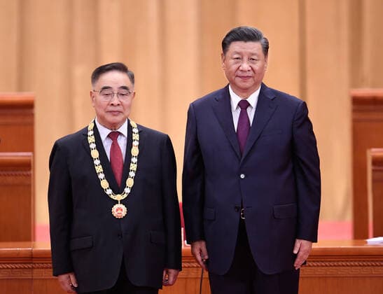 (200908) -- BEIJING, Sept. 8, 2020 -- Chinese President Xi Jinping, also general secretary of the Communist Party of China Central Committee and chairman of the Central Military Commission, presents a medal to Zhang Boli, recipient of the national honorary title, the People s Hero, during a meeting commending role models in the country s fight against the COVID-19 epidemic at the Great Hall of the People in Beijing, capital of China, Sept. 8, 2020. ) CHINA-BEIJING-COVID-19 FIGHT-ROLE MODELS-COMMENDATION MEETING (CN) ShenxHong