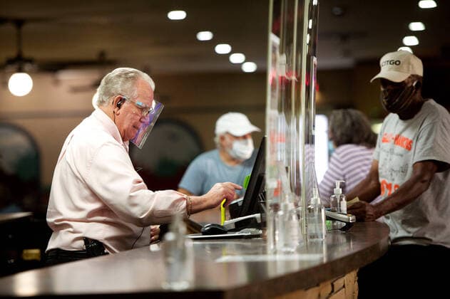 September 8, 2020, West Palm Beach, FL, USA: Night manager Murl Lent wears a face shield as Verdes Tropicana Bowling Lanes opens for business for the first time in six months in West Palm Beach, Florida on September 8, 2020. Plastic face shields, neck gaiters and masks with valves are not very effective in curbing the spread of coronavirus particles, according to two new studies from Florida Atlantic University in Boca Raton. West Palm Beach USA - ZUMAm67_ 20200908_zaf_m67_027 Copyright: xMeghanxMccarthyx