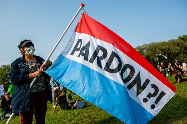 September 11, 2020, Utrecht, Netherlands: A protester wearing a face mask holds a big Dutch flag written on excuse me during the demonstration..After a fire destroyed Greece s largest refugee camp, leaving nearly 13,000 people without shelter, hundreds of people gathered to demand the Dutch Government and the EU to address this situation, support its fellow members and also take in an additional number of refugees. Utrecht Netherlands - ZUMAs197 20200911_zaa_s197_078 Copyright: xAnaxFernandezx