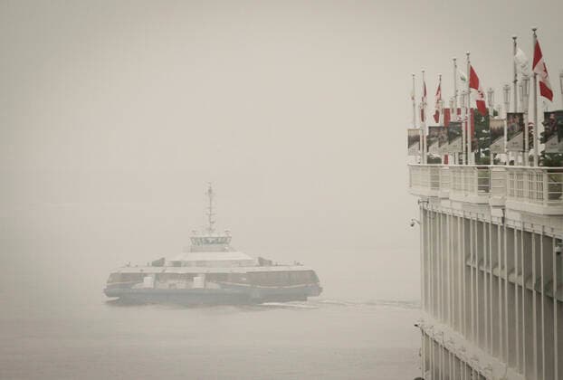 (200913) -- VANCOUVER, Sept. 13, 2020 -- A ferry is seen travelling on the water in heavy smog in Vancouver, British Columbia, Canada, Sept. 13, 2020. As smoke from U.S. wildfires continues to blow north towards Canada, Vancouver on Sunday was among the top five major cities in the world for bad air quality according to Air Quality Index (AQI). (Photo by Xinhua) CANADA-VANCOUVER- AIR QUALITY-U.S.-WILDFIRE SMOKE LiangxSen 