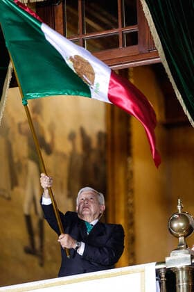 (200916) -- MEXICO CITY, Sept. 16, 2020 -- Mexican President Andres Manuel Lopez Obrador waves a Mexican flag on the central balcony of the National Palace during the Independence Day celebrations in Mexico City, capital of Mexico, Sept. 15, 2020. (Photo by Xinhua) MEXICO-MEXICO CITY-INDEPENDENCE DAY-CELEBRATION FranciscoxCanedo 